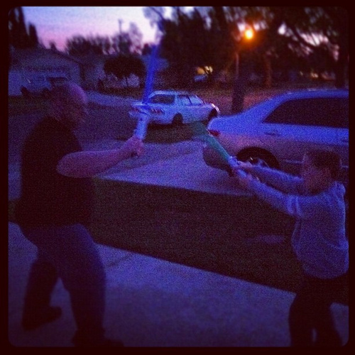 Father & Son Light Sabers at Sunset